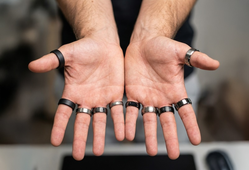Hands displaying several smart rings